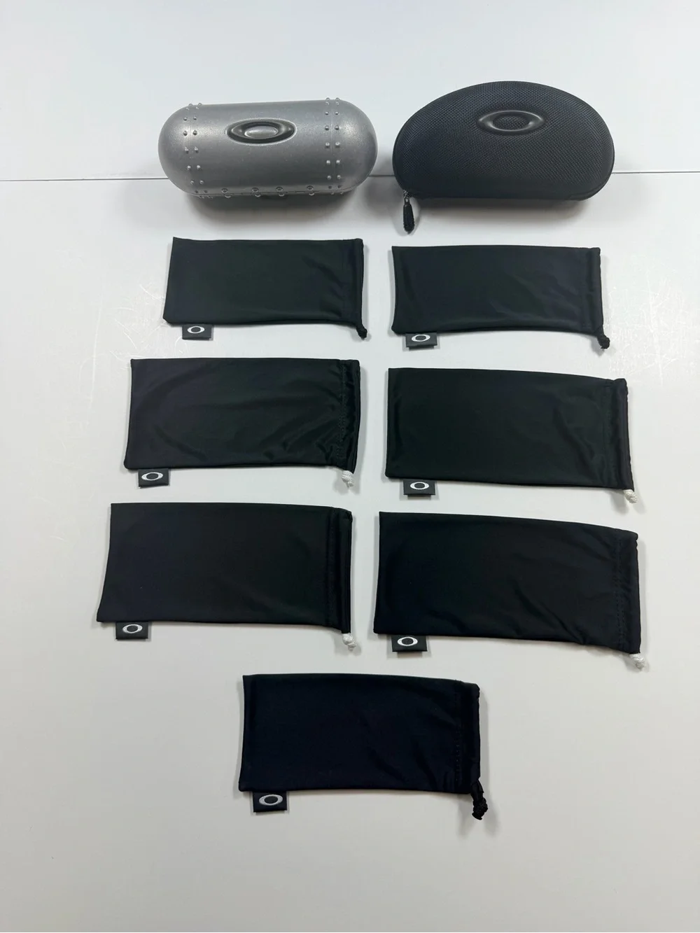 Oakley Black & Silver Hard Cases with Seven Black Microfiber Pouches
